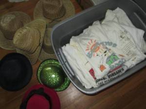 Covered tote of assorted t-shirts, ...