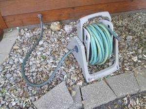 Plastic hose reel with garden hose...