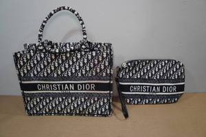 lot 121 image: Christian Dior BookTravel Tote with Accessory Bag