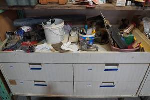 lot 409 image: Contents of Cabinet Top - Stapler, Tester, Can Crushers