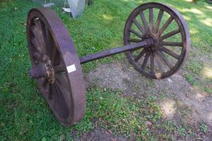 lot 16 image: Antique Axle with Wood Wheels