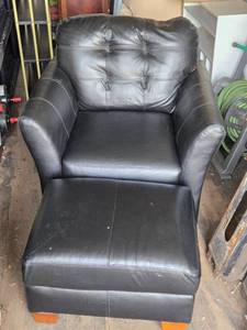 lot 6 image: Ashley Black Leather Armchair with Ottoman