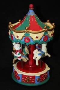 lot 490 image: 9 Collectors Musical Carousel - (RedGreenBlue with Santa Claus Dcor)