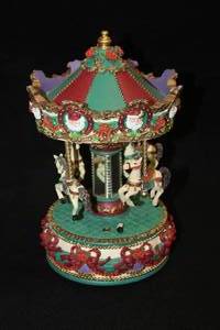 lot 488 image: 11 Collectors Musical Carousel - (RedGreenPurple with Santa Claus Dcor)