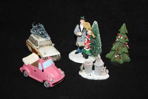 lot 1102 image: Lot of (5) Assorted Holiday Figurines - Violinist, VW Beetle Convertible, Famil Truckster with Tree, Raccoons in Trash Cans