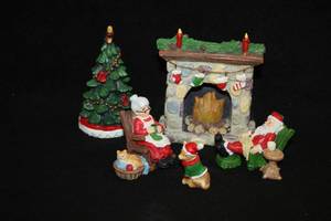 lot 1104 image: Lot of (5) Assorted Holiday Figurines - Santa and Mrs. Claus Around Fireplace with Christmas Tree, Dog and Cat