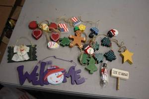 lot 1116 image: Lot of (25) Wooden Holiday Dcor GardlandSigns - Welcome, Easter Egg, Snowmen, American Flag, Hearts, Christmas Trees, Let It Snow Sign and more