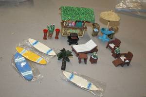 lot 1181 image: Lot of (19) Assorted Tropical PatioCabana theme Figurines - Tiki Bar, Patio Set, Surf Boards, Loungers and more