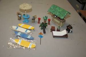 lot 1182 image: Lot of (17) Assorted Tropical PatioCabana theme Figurines - Tiki Bar, Patio Set, Surf Boards, Loungers and more