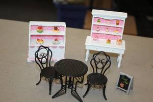 lot 1183 image: Lot of (6) Assorted Collectible Figurines - Patio Set, Food Sign, Kitchen Tables with Cakes