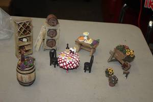 lot 1185 image: Lot of (11) Assorted Collectible Figurines - Wine Rack, Beer Kegs, Wine Barrel with Grapes, Dinner Table Set, Wheelbarrow with Flowers