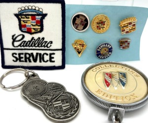 lot 87 image: CADILLAC Lapel Pins - 6, Embroidered Service Patch, Buick Collector Edition Hood Ornament, Cadillac Key Chain
