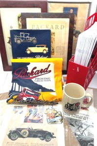 lot 253 image: Packard Lot Includes Packard Emblem, Framed Ads, New T-Shirt, Magazines & More