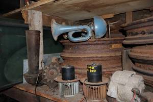 lot 3A image: Shed...1930 Chevy Coupe Parts & Pieces Entire Center Shelf of Rims, Horn Muffler Etc.