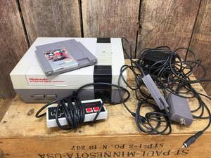 lot 232 image: Vintage Nintendo Entertainment System NES-001 with Contra Cartridge