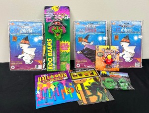 lot 86 image: New Halloween Cutouts, Spooky Walker Figurine, Lisa Frank Scary Whistles, Glasses, Boo Beam Light and More
