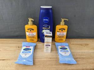 lot 64K image: New Assorted Beauty Items - Gold Bond Body Lotion, Nivea Body Wash, Neutrogena Clear Face Sunscreen 60, Cetaphil Cleansing Cloths W