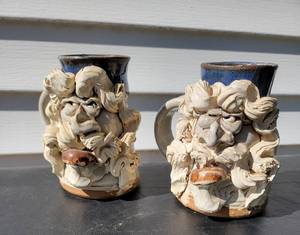 lot 54 image: Art Pottery Exaggerated Face Mugs, set of 2