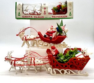 lot 138 image: Vintage BRADFORD CHRISTMAS DECORATIONS THE UNBREAKABLE KIND Plastic Waving Santa Claus in Sleigh with Toys & White Reindeers - QTY 3