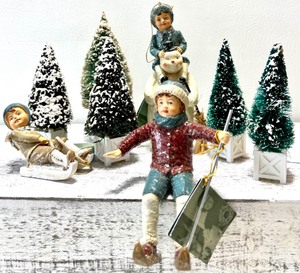lot 247 image: Trio of BETHANY LOWE DESIGNS Snow Fun Figures with 5 Vintage Bottle Brush Holiday Trees