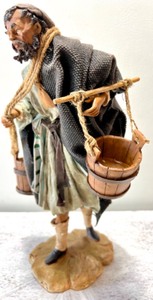 lot 254 image: Neapolitan Nativity Collection by DEPARTMENT 56 - Man Carrying Water Figure