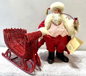 lot 396 image: KURT S ADLER FABRICHE COLLECTABLES Santa Figure with Red Wicker Sled