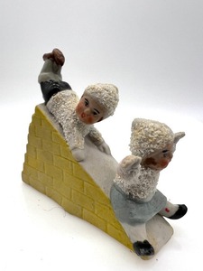 lot 447 image: Antique HERTWIG - GERMAN Snow Babies Sliding Down a Hill Bisque Figurine