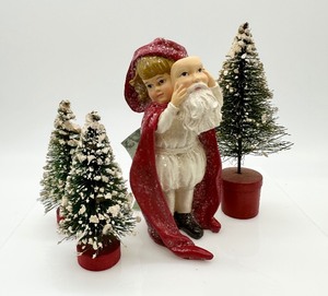 lot 555 image: BETHANY LOWE DESIGNS Girl with Santa Mask Figurine and Bottle Brush Trees