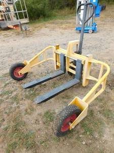 lot 44 image: Yellow Air Tire Pallet Jack  Cart