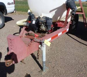 lot 8 image: 1,000 gallon poly tank on running gear, with pump and motor