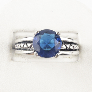 lot 130 image: Blue Round Cut Stone Silver Tone Base Metal Ring. Size 8 - 8.25.