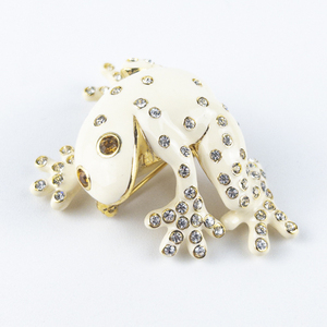 lot 229 image: Joan Rivers Cz Accented White Enamel Gold Tone Base Metal Brooch .