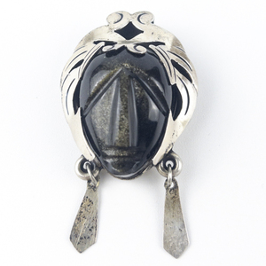 lot 240 image: PJB - Taxco Mexico  AztecMayan Warrior Mask, Set With Golden Sheen Obsidian Sterling Silver PendantBrooch . Two Dangling Elements.
