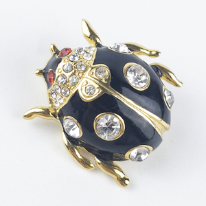 lot 253 image: Black Ladybug Rhinestone Accented Gold Tone Base Metal Brooch .