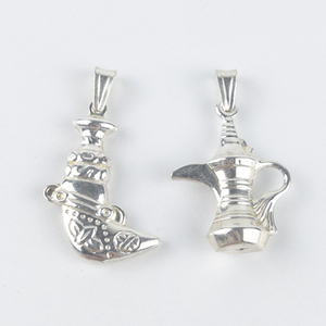 lot 88 image: Nicol (Arezzo, Italy)  Group of two Italian boot & jug sterling silver pendants (no chain).