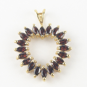 lot 105 image: Garnet Accented Heart gold tone base metal pendant (no chain).