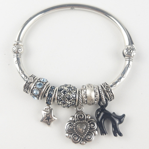lot 279 image: Brighton  Eight Charm  Silver Tone Base Metal Hinged Cuff Charm Bracelet.