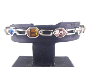 lot 291 image: Nolan Miller Elegant Multicolored Gemstone Silver Tone Base Metal Station Bracelet.
