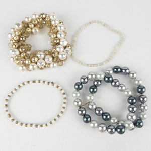 lot 215 image: Group of 4  Base Metal Bead Stretch Bracelets .