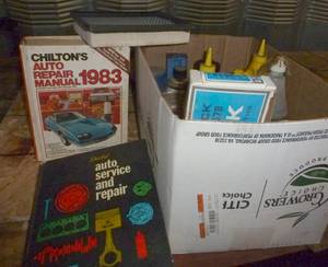 lot 15 image: Box full of garage oils etc and 2 auto repair manuals