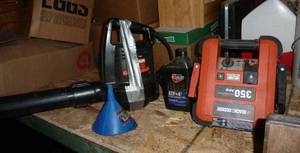 lot 35 image: Black and Decker jump pack, leaf blower, transmission fluid, funnel, 2 sets of mud flaps