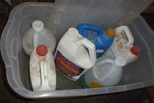 lot 61 image: four anti-freeze jugs 34 full or more