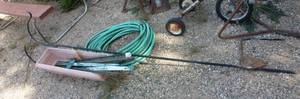 lot 192 image: shepherds hook, garden hose, planter box