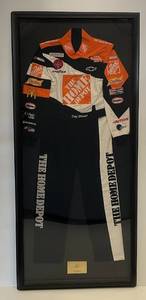 lot 1 image: Framed With Signed Brass Plate Tony Stewart Winston Cup Fire Racing Suit # 10197 (34 x 76)