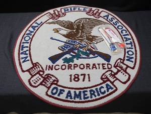 lot 41 image: NRA CIRCLE RUG & GUN LOCKS