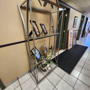 lot 13 image: Glass And Metal Shelf Measuring 33 X 17 X 89. Contents Not Included.