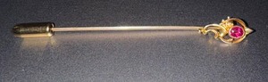 lot 25 image: 14K Gold Stick Pin with a Ruby Stone and Ornate Design