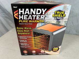 lot 133 image: New Handy Heater Pure Warmth Ceramic Space Heater with LED Lights