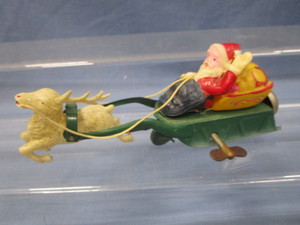 lot 65 image: Celluloid Santa On Metal Sleigh Windup