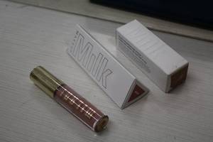 lot 241 image: Milk Flex Foundation Stick Golden Sand, Kush Lip GlazeGloss Nova, Nourishing Lip Plumper
